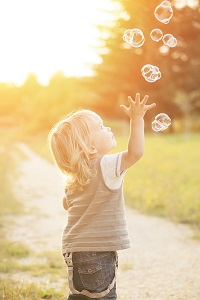 child catching bubbles